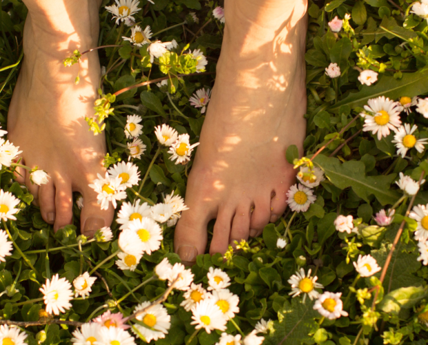 Walking barefoot on the ground in nature.