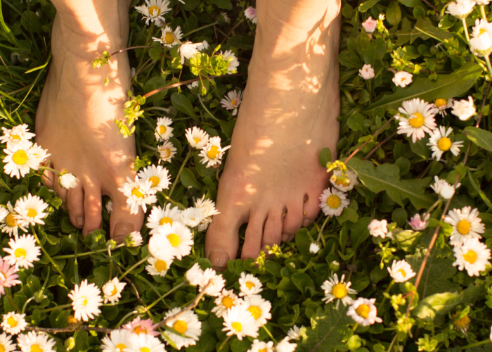 Walking barefoot on the ground in nature.